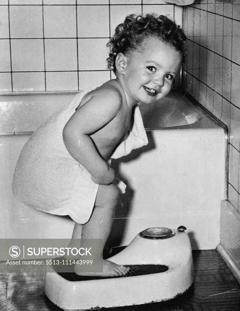 Weight's right - and remember, healthy children eat just an much as they need. Baby busy playing makes a good picture - especially if she has an engaging smile like this.... October 16, 1953.