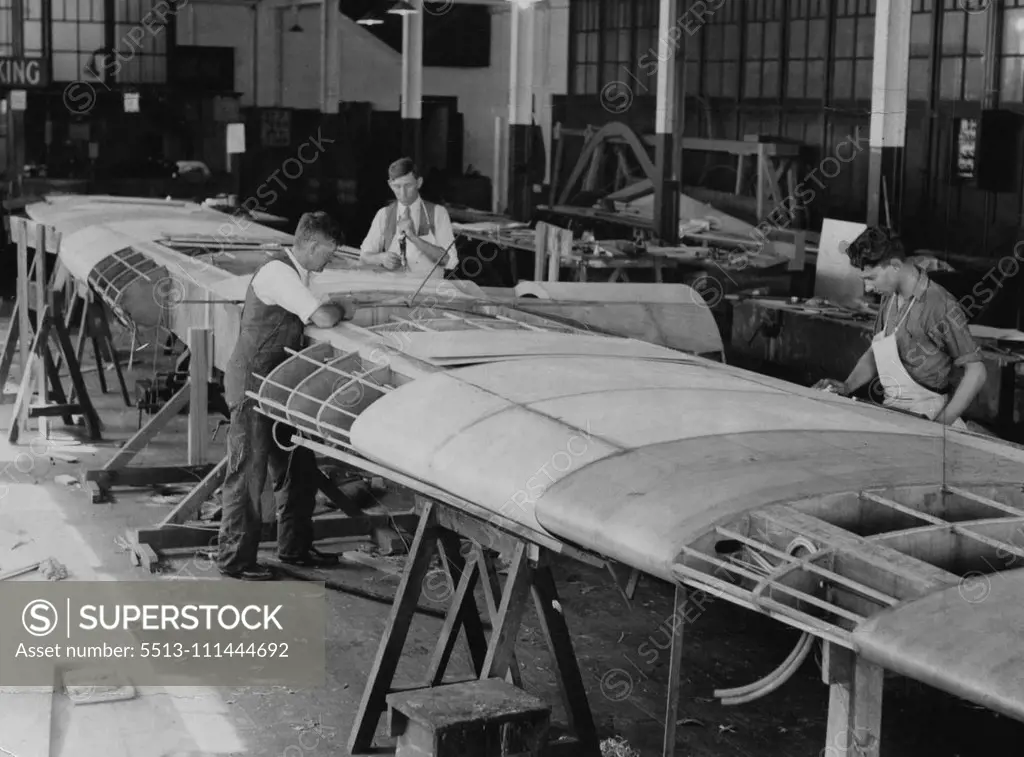 For New Zealand Flight -- Working on the wing of the Codock, the two -engined monoplane, which is being completed at Cockatoo Dock. Squadron-Leader T. W. White, on his recent arrival from New Zealand, said he expected this 'plane would be used by Sir Charles Kingsford-Smith and himself to fly to New Zealand. November 22, 1933.