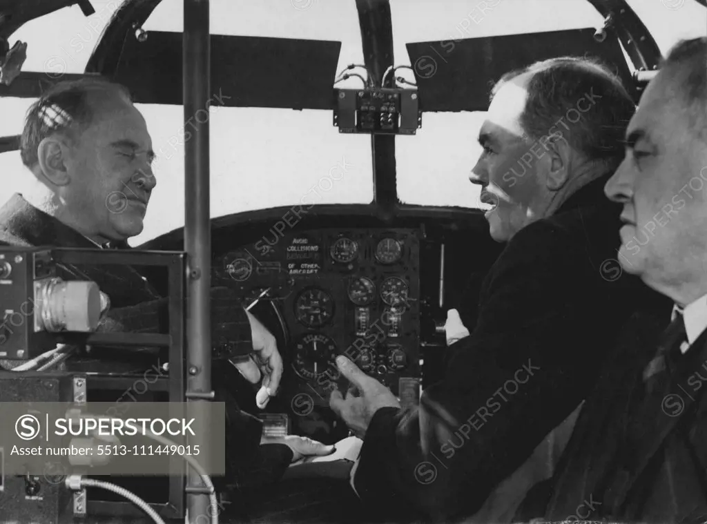 Premier Mc. Kell & Police Commissioner Mackary sit at the controls of the Police arrs at Mascot today. July 22, 1946. (Photo by Bob (Robert) Rice/Fairfax Media).