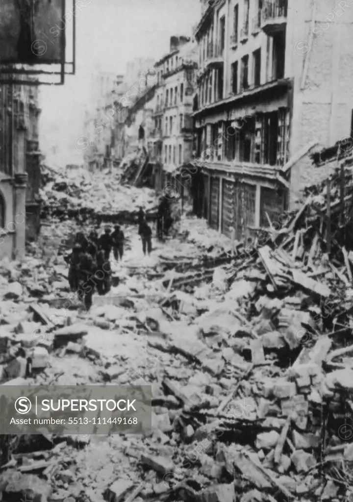 Allies Push Through Caen -- Continuing the drive which wrested the city of Caen from enemy hands, Allied troops pour through the Normandy coast community in pursuit of withdrawing German forces, giving them no opportunity to regroup. These troops are en route to the front. July 11, 1944. (Photo by Associated Press Radiophoto).