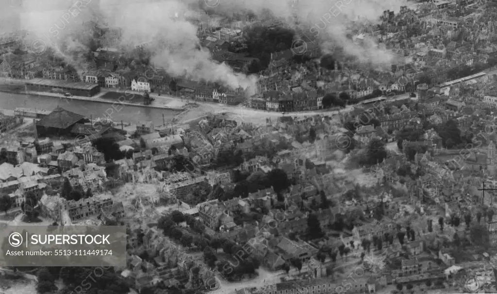 The Capture Of Caen -- The town of Caen was captured today, July 9th, after the offensive opened by British and Canadian troops of general Dempsey's Second Army at Dawn on July 8th. This R.A.F. reconnaissance picture, which was taken in the first week of the Normandy campaign shows fires burning in the town. July 01, 1944. (Photo by British Official Photo).