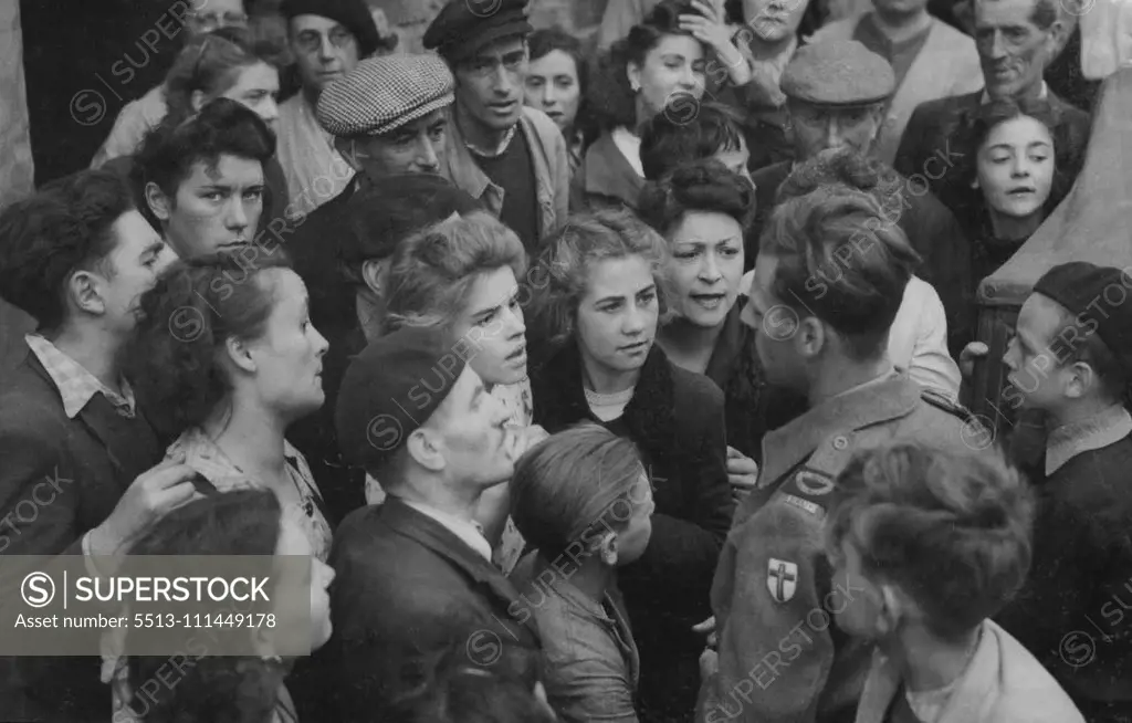 News For Caen Townspolk -- Citizens of Caen eagerly gather around Pierre Lefevre, the French Commentator of the B.B.C. for the latest news after the town was taken by British and Canadian Troops. September 11, 1944. (Photo by Associated Press Photo).