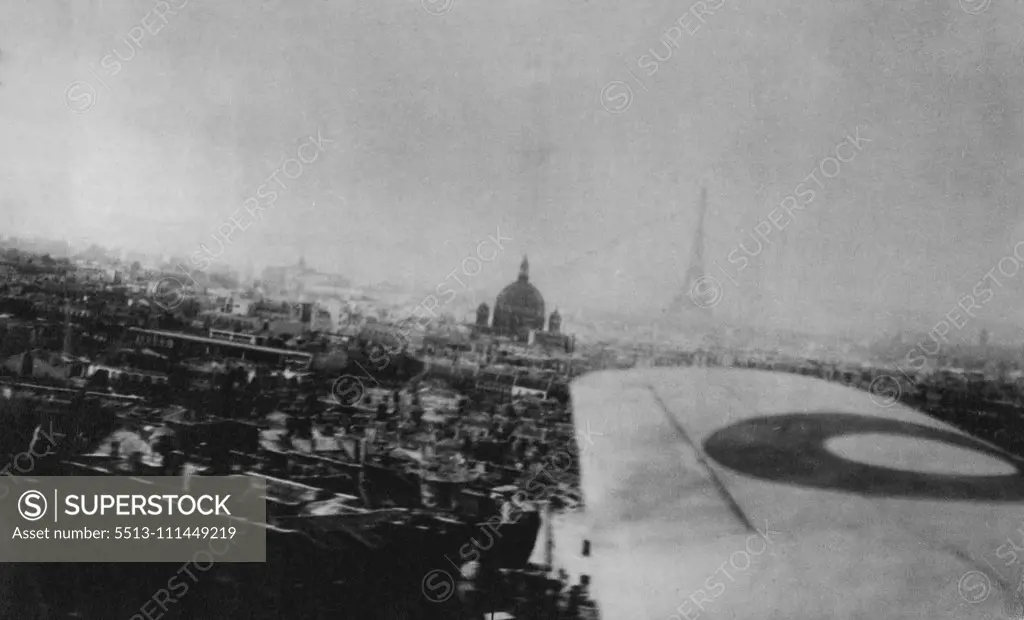 "Scraping The Rooftops Of Paris": The Pictures And The Pilot -- A view of Pars is taken from the coastal command plane. In the background is the Eiffel tower. The domed building is Les invalids Napoleon's is tomb. These close-up photographs of Paris were taken from an aircraft of coastal command, R.A.F. Which flew over the French capital,. They establish the "Roof-hopping" height at which the pilot flew. The pilot dropped the tri-color on the Arc de Triomphe and afterwards cannon-shelled a buil