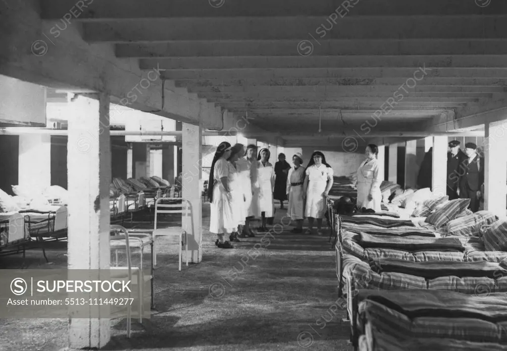 Air Raid Precautions in Paris A First Aid Shelter: Forty first aid centres have been established which will be capable of dealing with 5,000 casualties. The one shown in our photograph is the Puteaux shelter and, like the others, is gas and bomb proof. Our photograph was taken during one of the weekly practices at this shelter. May 10, 1939.