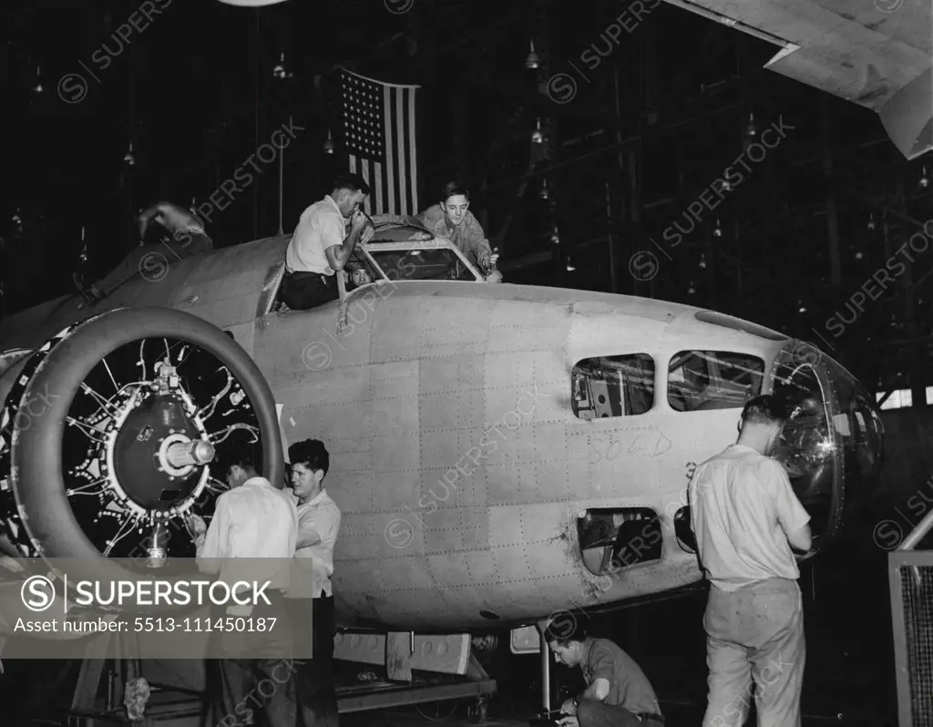 Building A Bomber -- In another picture you saw Palmer working on a plane motor. Thoroughly conversant with plane construction, He's shown above (left) working on the Windshield of a Lockheed Hudson Bomber. Note that some wag has scribbled "sold" on the fuselage, near the nose. July 18, 1941. (Photo by ACME).