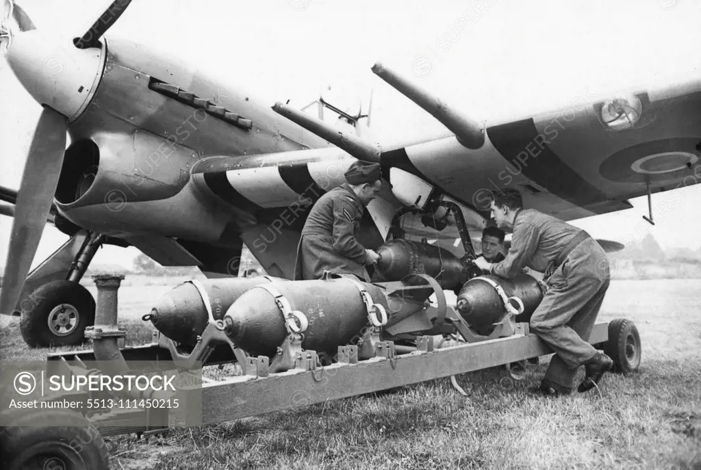 The Hawker Typhoon - Britain's Latest Fighter - Bomber -- Britain's latest fighter-bomber-The Hawker Typhoon - in flight, Its two 500lb bombs can be seen slung beneath the wings, one between each pair of 20 mm. cannon. Latest and most deadly fighter bomber in the armoury of the R.A.F., the Hawker Typhoon is fitted with a Napier Sabre engine and armed with four 20 mm. cannon two in each wing - it carries two 500 lb. bombs. Its high speed and great range enable it to penetrate deep into enemy terr