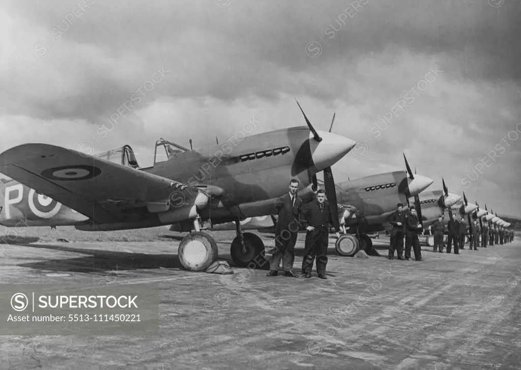 American Kittyhawks and their N.Z. Pilots at an operational air station in New Zealand -- Mechanics attached to the Squadron stand by the Kittyhawks after checking the machines engines. November 19, 1942. (Photo by The "N.Z Herald").