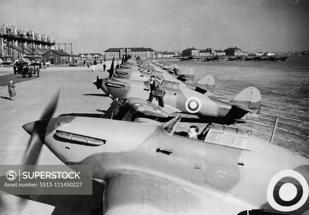 Demonstration Of Squadron Of Hawker "Hurricane" Fighters -- A line of the Squardon's Hawker "Hurricane" Fighters on the concrete at Northolt this afternoon. A demonstration of new Hawker "Hurricane" Fighter Air craft was given this afternoon by No.111 (F) Squadron at Northolt Aerodrome, Middlesex, Squadron-Leader Gillan recently flew one of these aircraft from Edinburgh to London at an average speed of 408 miles an hour. March 6, 1938. (Photo by Topical Press).