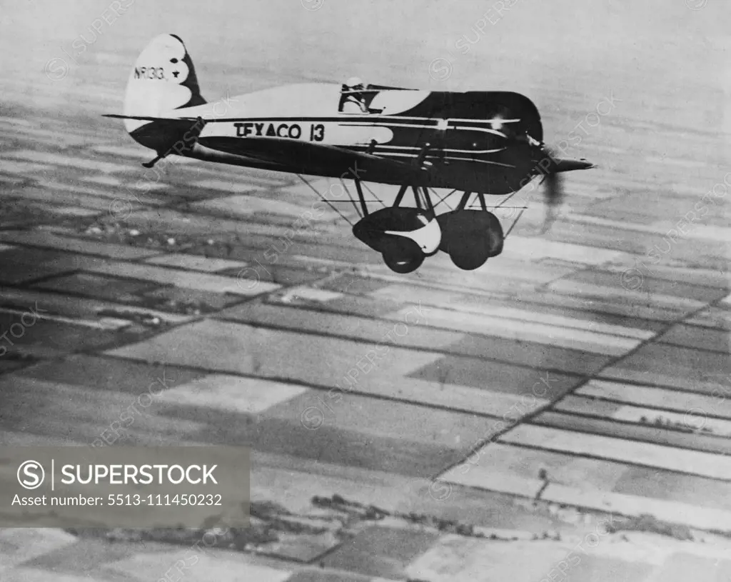 Doing The Bare 240 miles an hour - Capt. Hawks testing his machine for his attempt to shatter the record from New York to Los Angeles. August 19, 1930. (Photo by International News Photos Inc.).