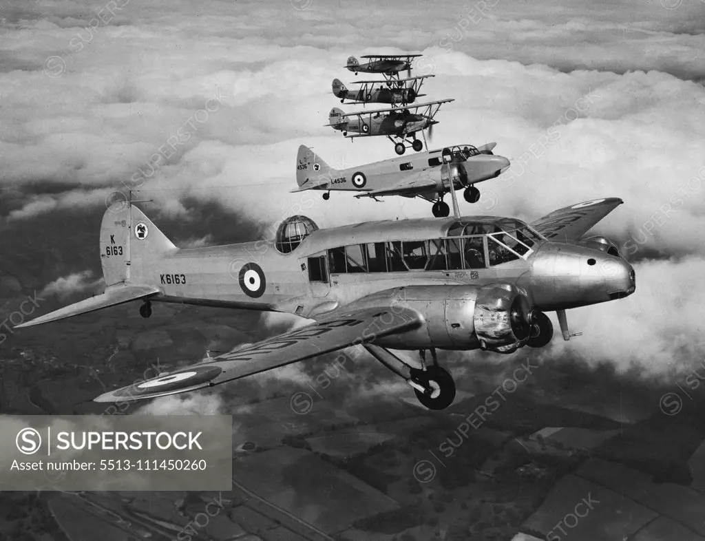 An Unusual Formation -- Formation flying of aircraft of widely different performances such as this is a difficult feat. These aircraft all belong to the central Flying School at Upavon. All the aeroplanes in this photograph are different. Reading from the camera they are the Avro "Anson" (coastal reconnaissance aircraft), "Oxford", twin-engined trainer, "Hart", bomber and training aircraft, Avro "Tutor" and "Fury," single-seater fighter. July 27, 1938. (Photo by Paul Popper).