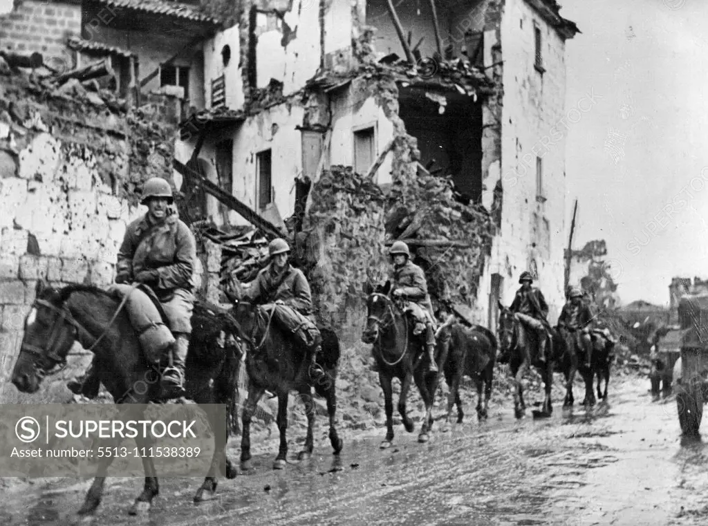 New U.S. Cavalry Advance in Italy: A U.S. cavalry detachment of the Allied Fifth Army passes through a shell-torn Italian town. The mounted men are known as Provisional Mounted Reconnaissance troops and were organized early in the Allied campaign in Italy. They have proved effective in destroying German machine gun nests and artillery emplacements inaccessible to motorized forces. January 10, 1943. (Photo by U.S. Office of War Information Picture).