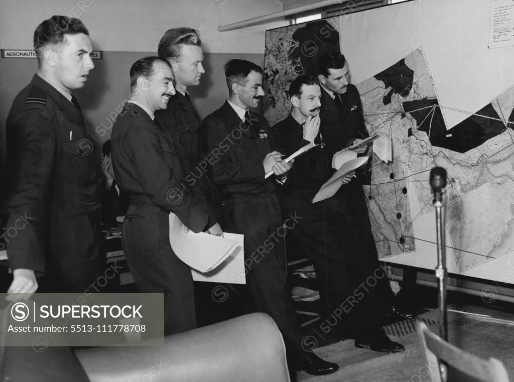 Under Starters Orders -- RAF Fliers who are taking part in the race are here seen in the briefing room at London Airport today. (Left to right) Flt. Lt. J.W. Harper of Sunderland., of Middlesex, Sqd. Ldr. L. Press of Kent., Sqd. Ldr. R. Currie of Manchester and Flt. Lt. R.M. Furze, of Herts. Lined up under starters orders, entrants for the London- New Zealand air-force were on show to the public at London Airport today. Although the instruments have been sealed in readiness for the race which st