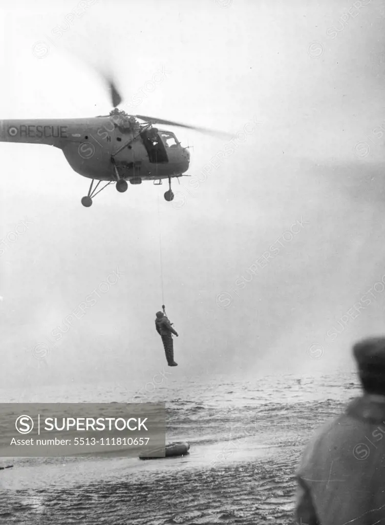 Rescued From ***** Sea -- A 'Guinea-Pig' is lifted from his dinghy by the helicopter winch and then flown to be landed on the nearby lifeboat. Eleven men were ***** dinghies in the bleak ***** North Sea recently. The rescued men were not however genuine but human guinea-pigs in a helicopter rescue demonstration, 15 miles off Tayport. The exercise was performed by members of 275 search and rescue squadron, one of the only two rescue squadrons in Great Britain, and based near middlesbrough. Decemb