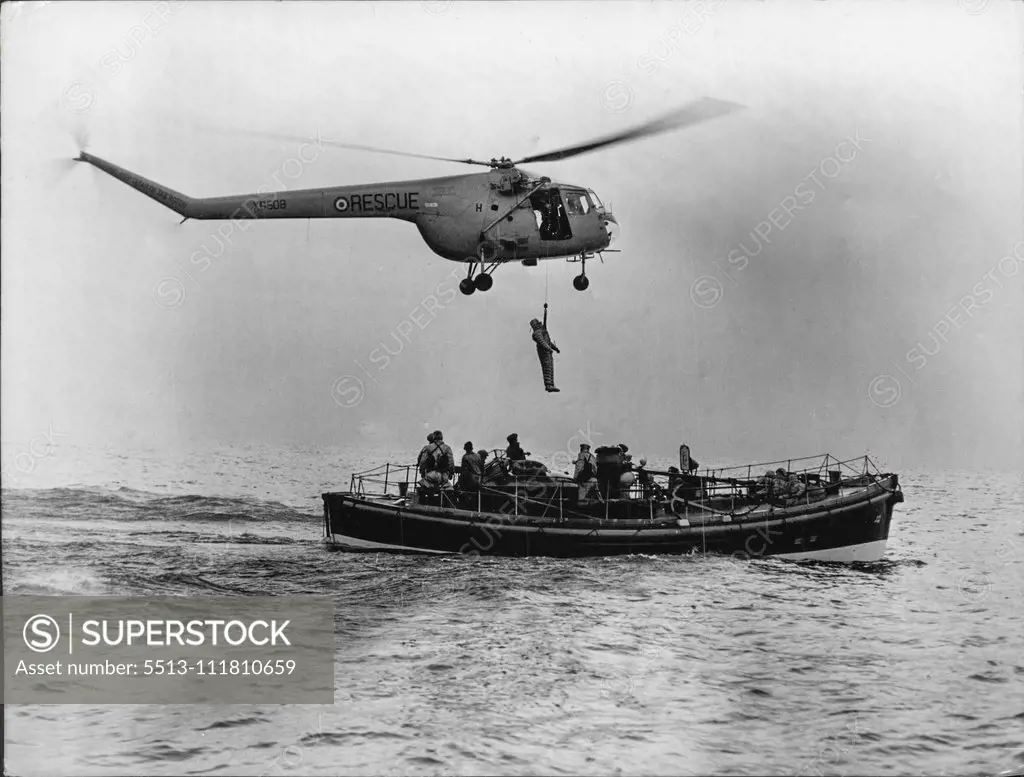 Rescued From The North Sea -- An airman is put aboard the Broughty Ferry lifeboat after being picked up, from the sea by the helicopter. Eleven men were rescued from drifting dinghies in the bleak waters of the North Sea recently. The rescued men were not however genuine but human guinea-pigs in a helicopter rescue demonstration, 15 miles off tayport. The exercise was performed by members of 275 search ***** because squadron, one of the only two ***** in Great Britain, and based *****. December 