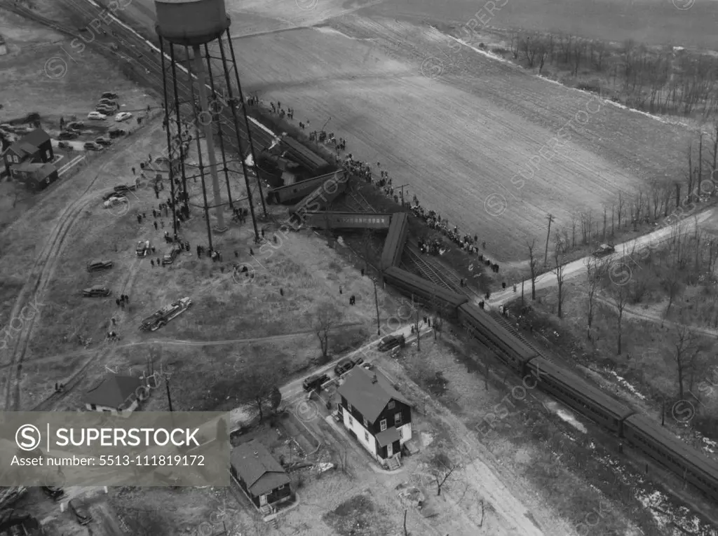 Long Island Railroad Wreck : Five passenger cars of the Long Island railroad's Jamaica to Port Jefferson train lie across the tracks at Kings Park, New York, Feb. 16, after derailment. Police reported that more than a score of the passengers were injured. Engine of train lies at left. February 16, 1947. (Photo by Associated Press Photo).