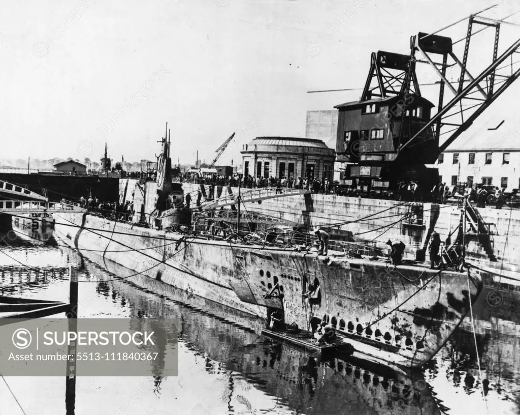 Dead Taken From Squalus -- The ill-fated submarine Squalus is pictured in drydock at the Portsmouth Navy Yard where she was placed last night after one of the most outstanding salvage jobs in sea history. It was reported today that 24 of the 26 dead in the submarine had been taken from the craft where they had been entombed since May 23rd when the ship went to the bottom after a trial dive. The craft which cost the Navy almost $4,000,000, will be put back in service after a overhauling. Septembe