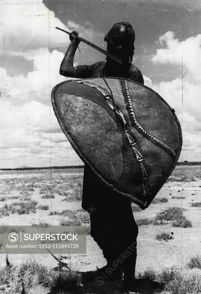 A proud warrior from the nomadic Masai tribe dressed in his traditional red robe and carrying his ancient weapons. Proud Masai warrior poses with spear and cowhide shield. June 20, 1955. (Photo by Toni Schuler, PIX Incorporated). ;A proud warrior from the nomadic Masai tribe dressed in his traditional red robe and carrying his ancient weapons. Proud Masai warrior poses with spear and cowhide shield.