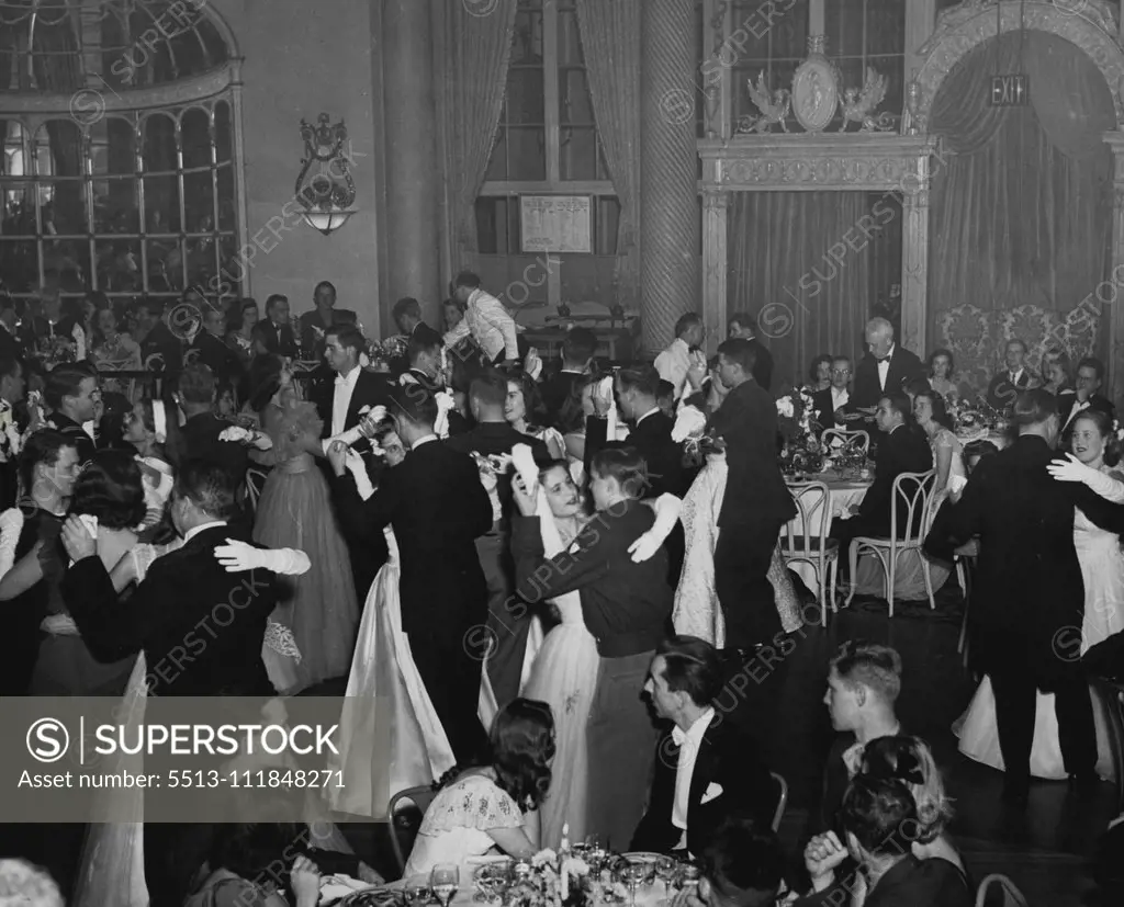 The Debutante Waltz is the featured dance at debutante dinner parties held in the Oval Room of the Ritz-Carlton Hotel in New York in advance of the Grosvenor Debutante Ball. Girls making their debut and their escorts alone take part in this special number. Some dance it with their fathers. August 22, 1947. (Photo by ERNEMAC Photo Service). ;The Debutante Waltz is the featured dance at debutante dinner parties held in the Oval Room of the Ritz-Carlton Hotel in New York in advance of the Grosvenor