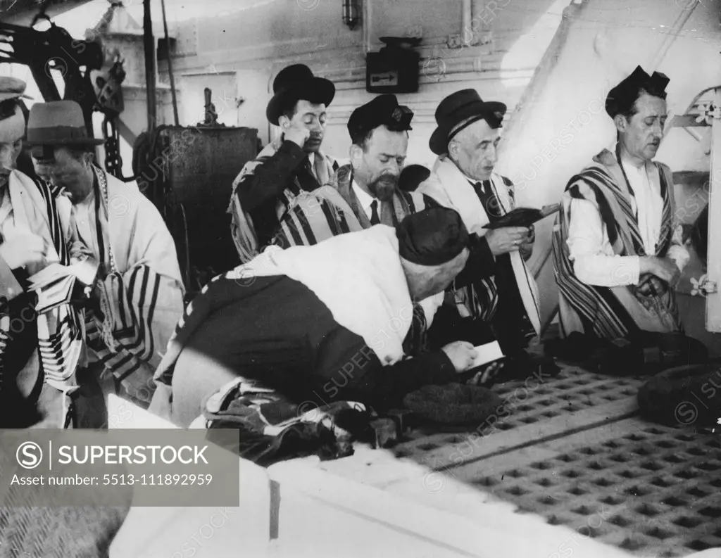 Refugees Road To Freedom -- A constant stream of refugees is flowing from Europe to America, seeking refuge from oppression and persecution. The cameraman accompanied a party of German Jewish refugees travelling from Berlin to New York. Refugees praying on board the liner "Vulcania," which is taking them to America and a new life. They offer thanks for their liberation and solicit divine blessing for the days that lie ahead. They are wrapped in their "talliths" (praying mantles) and wear their "