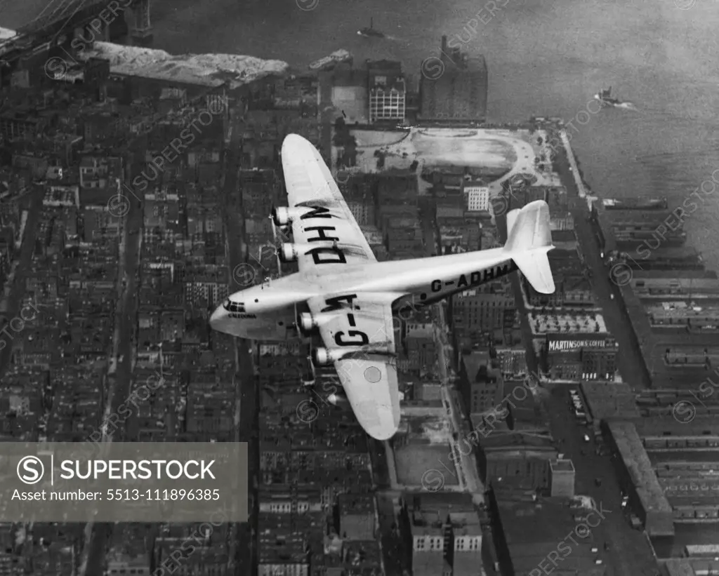 British Flying Boat Soars Over Manhattan -- Before the British Imperial Airways flying boat Caledonia alighted at Port Washington today to complete the first westward trans-Atlantic voyage of a commercial company's seaplane, the big ship circled lazily over Manhattan. The Caledonia is shown just before the last stage of the trans-ocean journey, from Montreal, was completed. July 9, 1937. (Photo by Associated Press Photo).;British Flying Boat Soars Over Manhattan -- Before the British Imperial Ai