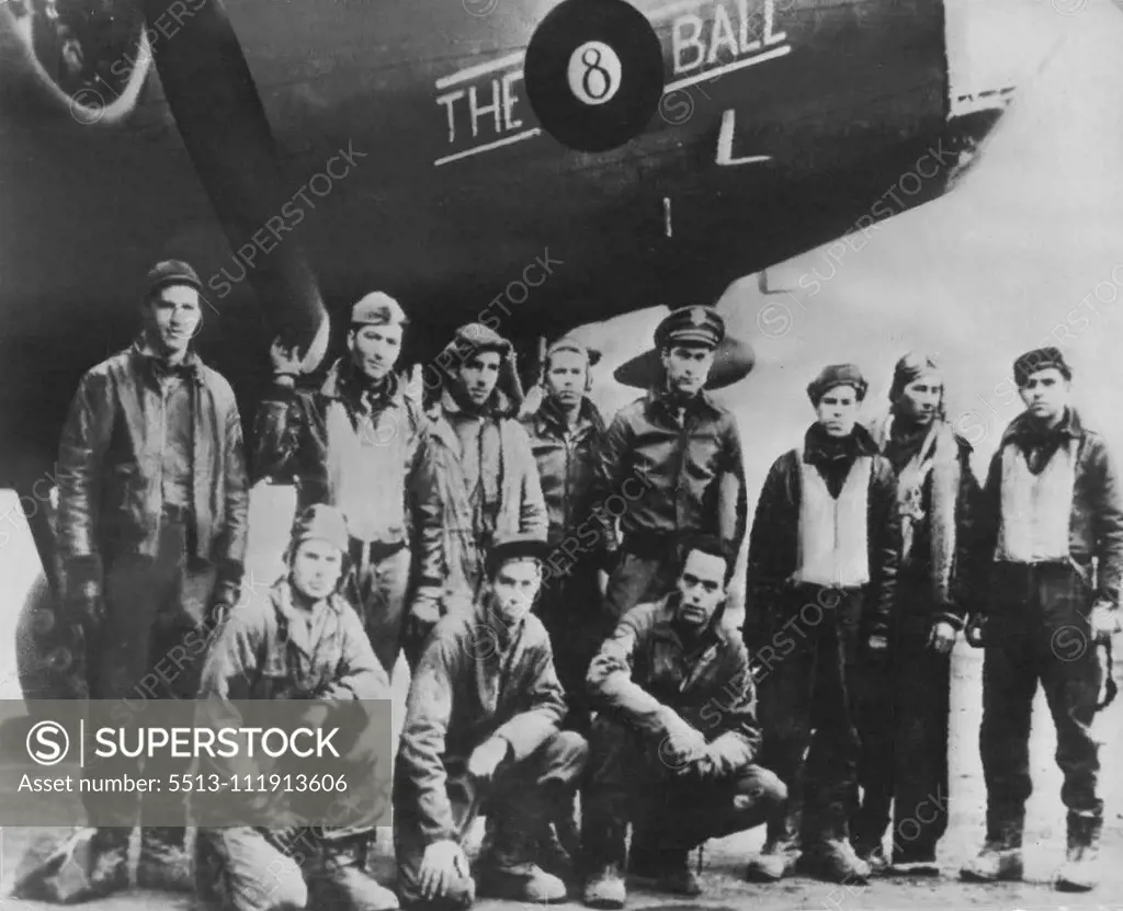 Crew of U.S. Bomber After Raid On Germany -- A U.S. Army bombing crew poses for a picture under the nose of "The Eightball", their Flying Fortress, before entering their recreation shack somewhere in England for hot coffee and a cigarette. The plane was one of many that raided Wilhelmshaven and Emden in the first American daylight raid on German territory. March 22, 1943. (Photo by Interphoto News Pictures, Inc.).