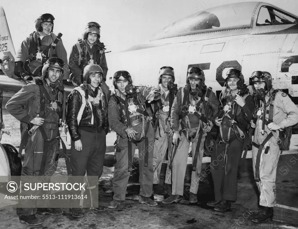 Mig Victors: An Airbase In Japan -- A group of happy young F-84 Thunder jet pilots of the Fifth Air Force's 27th Fighter Escort Group smile broadly. They have just returned from the, greatest aerial battle of the Korean war, in which about 115 F-84 Thunder lets and F-86 Sabrejets of the Fifth Air Force tangled with 80 enemy MIC-15 type fighter which tried to intercept, a large formation of B-29 Superforts April 12 near the Yalu River in North Korea. During a fierce, high-altitude battle, more th