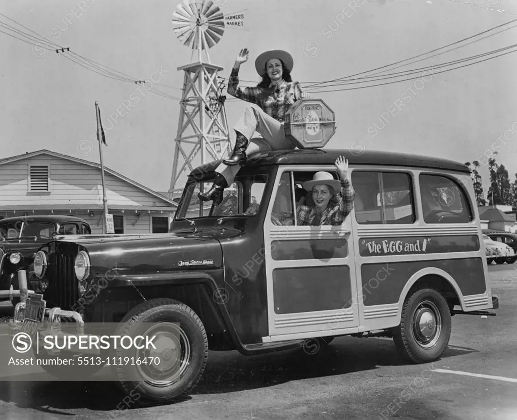 Movie starlets Judith Woodbury and Joan McTavish are pictured as they left Los Angeles' famed Farmer's Market enroute to New York City with a print of "The Egg and I." The girl featured in the movie version of the Betty MacDonald best­seller, also delivered a basket of fruit and a dozen eggs to New York's Mayor O'Dwyer--compliments of Claudette Colbert and Fred MacMurray, co-stars of "The Egg and I." February 09, 1948.