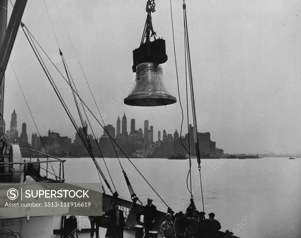 One of the 13 bells being unloaded from the steamship Excalibur at Jersey City, New Jersey. In background is the skyline of New York City. Thirteen replicas of the Liberty Bell, the first shipment of 52 to be used in connection with the Independence Savings Bond campaign of the U.S. Treasury Department, arrived recently (April 21, 1950) in the United States from Annecy, France, where they were cast. During the 6-week campaign, which begins May 15, 1950 and ends July 4, 1950, the bells will be ex