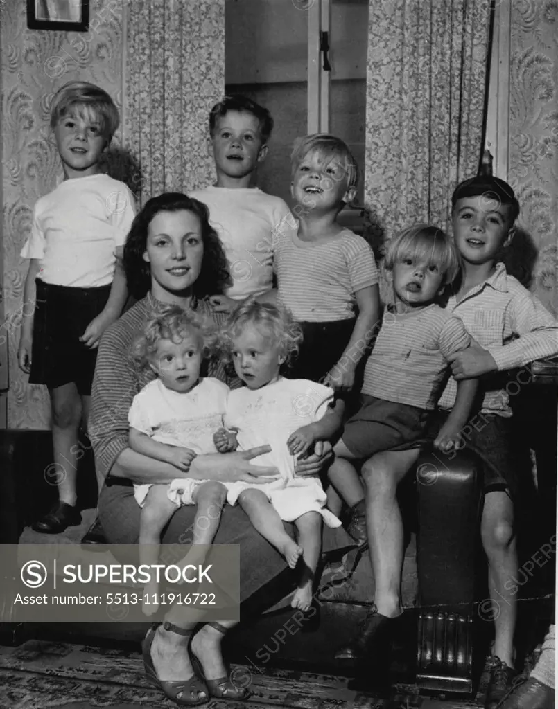 With Mrs. Eileen Moorman, 29, are one-year-old twins Kevin and Barry on her knee, and behind from left: Derek, 5, Terry, 7, John, 4, Paul, 2, and Clive, 8. August 28, 1952. (Photo by Daily Mirror).