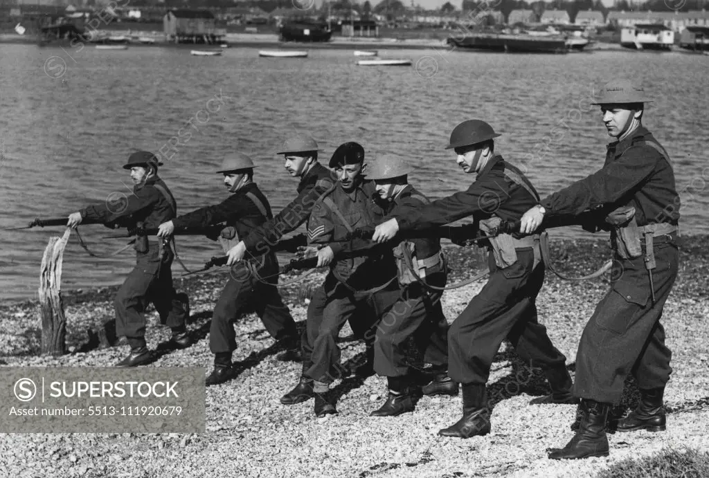 "British Made" Argentine Marines Train Here -- "This is how it's done" - Sgt. K.B. Jones R.M. of Deal, Kent, gives bayonet instruction to - left to right - First Captain Tulio C. Pavon; and Second Captains, Eduardon Sciurano; C.R. Fernandez' Lobbe; Jose Eyherabide; Horacio Uslenghi; Alberto J.B eretta, at Portsmouth.Two Lieutenants and 10 Sub-Lieutenants of the Argentine Marine Corps have arrived at the Royal Marine Barracks, Portsmouth, for six months training with British Marines. During their