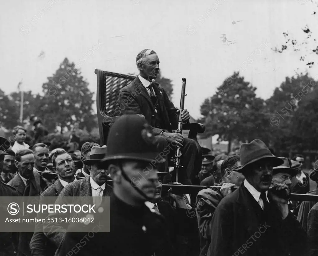 Veteran's Victory at Bisley. Company Sergeant Major Bayly, late of the 4th. Volunteer Battalion, Royal West Kent Regiment, being chaired after winning the King's Prize at Bisley with a score of 289. August 29, 1932.