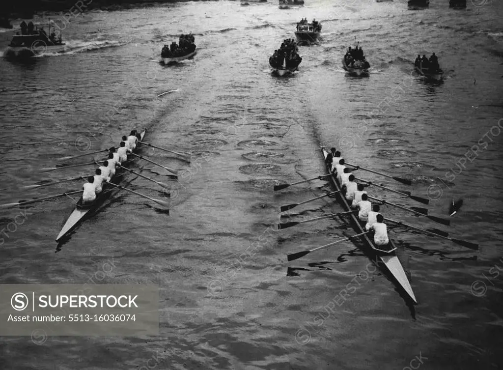 The race approaches Hammersmith Bridge. Oxford are on the right. Oxford supporters are chuckling over a victory for "psychological" warfare." They reckoned that their rumoured secret weapon for nerves had Cambridge worried from the start of this hundredth race, which Oxford won by for and a half lengths. For the Dark Blues, with four Australians in their crew, held the lead from the first stroke against the heavier Cambridge crew, who had been dosed with vitamin capsules. On the eve of the race there had been rumors that Oxford were taking phenobarbitone pills to steady their nerves. April 5, 1954. (Photo by Daily Mirror). 