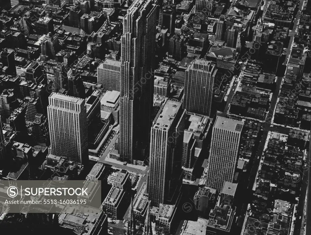 The Rockefeller Centre, New York -- This unique 15-building development in the centre of Manhattan occupies a little more than 12 acres between 48th and 51st Street and between Fifth Avenue and the Avenue of the Americas. The Esso Building, extreme right, forms the northern gateway to the Centre, with an entrance on 52nd. The building in the centre, of the picture, towering above all others, is the R.A.C. Building of 70 storeys. Right of it, and just behind the spires of St. Patrick's Cathedral, is the 41 -storey International Building. The 36-storey Time and Life Building stands at the extreme left of the photograph between 48th and 49th. July 28, 1954. (Photo by Camera Press). 