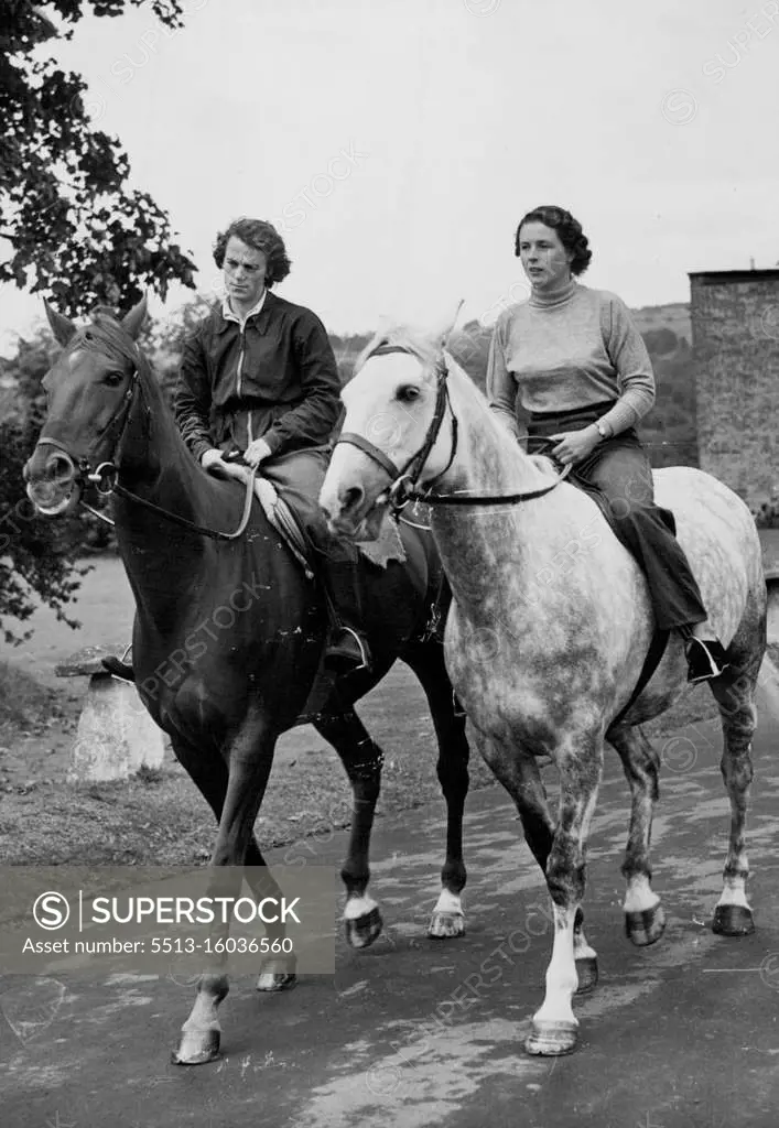 Pat Smythe To visit America And Canada -- Out for her daily exercise in a Cotswold lane near her home at Miserden (Glos) is Miss Pat Smythe mounted on Tosca (right) Accompanying her, mounted on Prince Hal (left) is her groom Miss Pauline Sykes, who will also go on the forthcoming trip to look after the horses. Britain's a leading horsewoman, 24-year-old Pat Smythe is one of a team of three riders being sent to America and Canada by the British show jumping Association this Autumn. In addition to Canadian and American teams, the British rides will also compete against teams representing Italy, Ireland, Mexico, the Argentine and perhaps Spain. September 21, 1953. (Photo by Fox Photos).