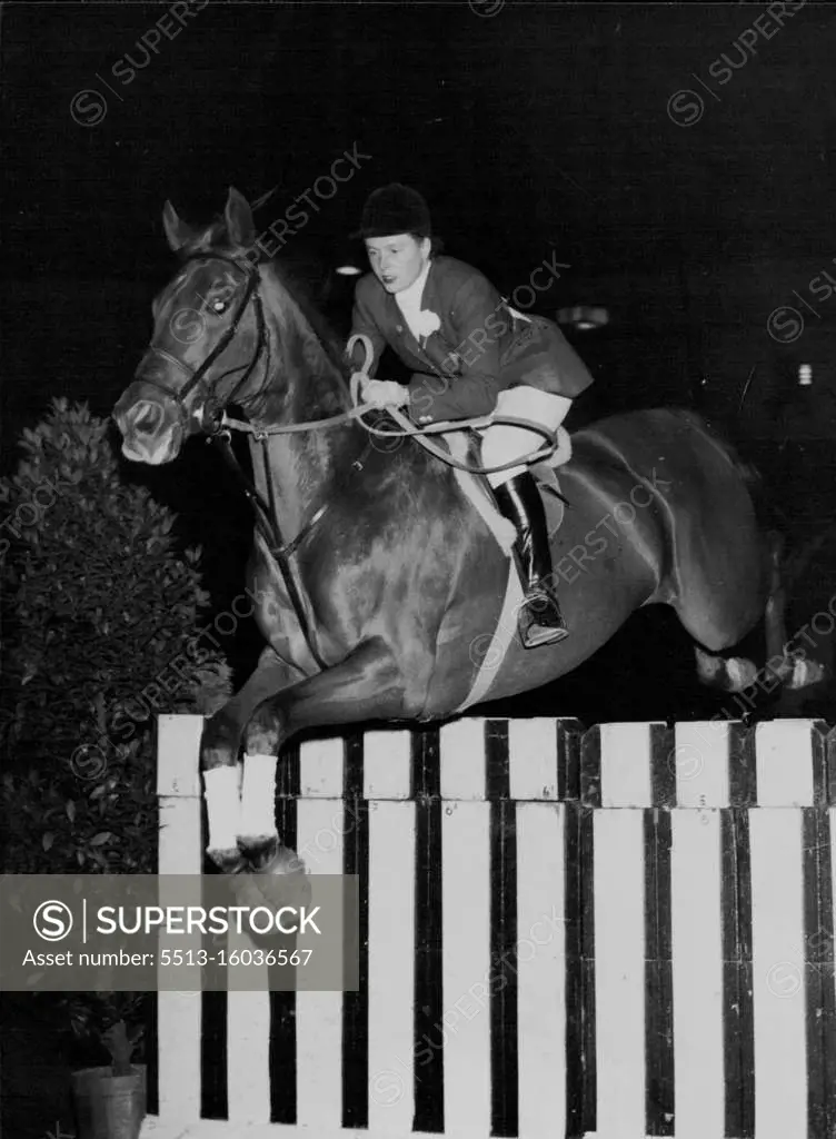 Well Clear -- Miss Pat Smythe, the popular international show jumper, takes "Prince Hal" over the sleepers during yesterday's jumping at the horse of the year show at Harringay. Pat finished second on Prince Hal in the "Horse of the year" competition, won by Mr. Ted Williams on "Sunday Morning". October 07, 1955. (Photo by Paul Popper Ltd.).