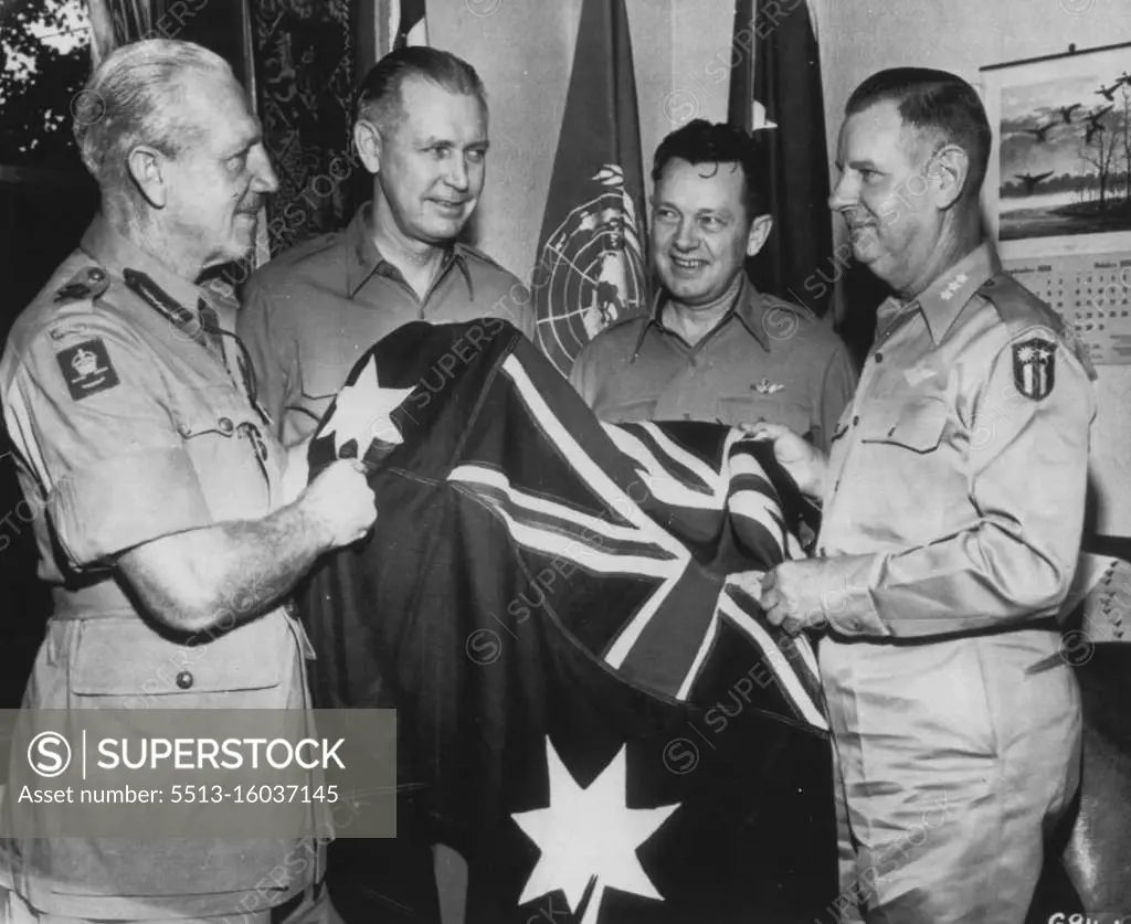 Close coordination between Australian United States Air Force units was the highlight of the above scene (Oct.13) as Lt. Gen. Sir Horace C.H. Robertson (left), commanding the British Commonwealth Occupational Forces, presents the national flag of his country to Lt. Gen. George E. Stratmeyer (right) Commanding General, Far East Air Forces. Mr. Gens. O.P. Weyland(center, left) and L.C. Craigie (center, right), witness the ceremony. October 16, 1950. (Photo by Associated Press). 