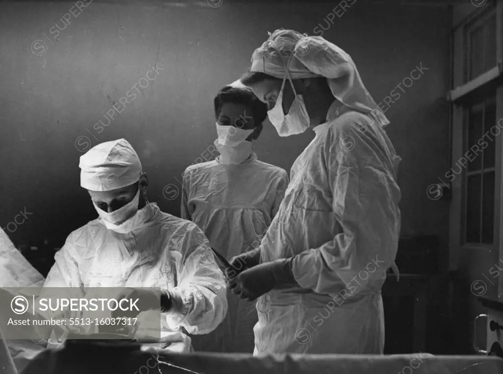 Life And Work Of A Hospital Matron -- The Matron (centre) calls in at the Operating Theatre to see a minor operation in progress. All nurses must take a course of Theatre training during the three years they are preparing for their final examination; a skilled team of trained nurses must be available at all times of day and night. Dr. Sava, an expert surgeon, also believed *****. March 12, 1954. (Photo by Camera Press).