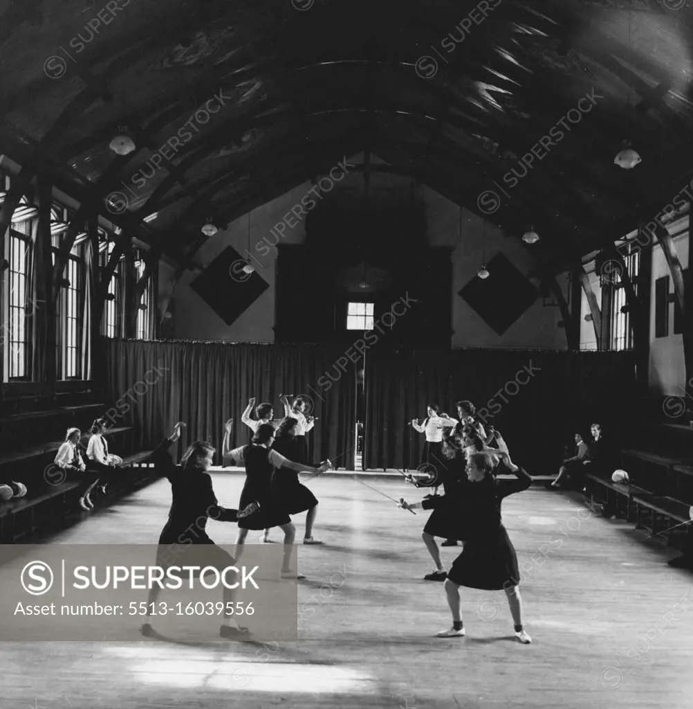 Wycombe Abbey School - A fencing class in progress in Big School, This hall was built for political meetings by Lord Lincolnshire from whom the Abbey was bought for the School' in 1896. March 3, 1949. (Photo by Tom Blau, Camera Press).