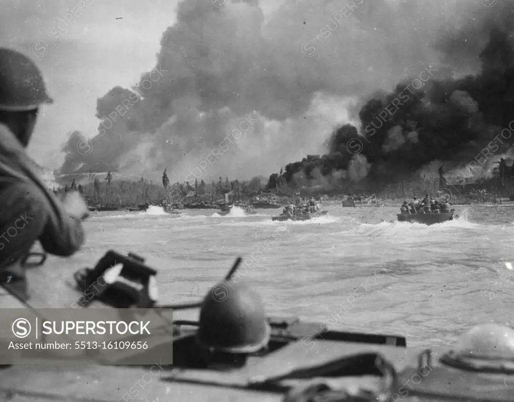 Last dash to shore, aboard American-manned alligators, during the landing of Australian troops at Balikpapan, Borneo. In background: smoke from ruins of enemy positions and from burning oil-wells. Shore installations were subjected to an intensive naval bombardment before the landing operation. July 12, 1945. (Photo by Australian Official Photo). 