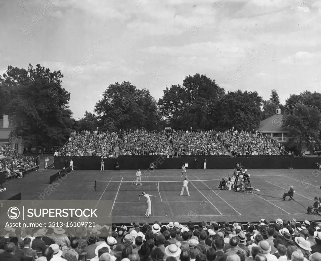 Davis Cup Doubles - Don Budge of the American team serving (foreground) as Australia won the double match from the United States to lead 2 to 1 in the American zone Davis Cup finals. Budge and Gene Mako battled Jack Crawford and Adrian Quist (in shorts) for five sets only to lose 4-5, 2-6, 6-4, 7-5, 6-4. May 31, 1936. (Photo by Associated Press Photo).