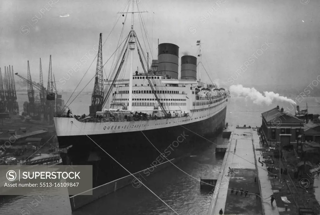 The "Queen Elizabeth" In Dry Dock -- The "Queen Elizabeth" moving into the King George V dry dock at Southampton today, Wednesday. After a hold-up of 12 hours, due to unfavourable weather, the "Queen Elizabeth" moved today, Wednesday, from 101 berth in Southampton new dock to the King George V Dry Dock, for the next stage of her conversion from troopship to luxury passenger liner. The operation of moving the giant liner into the dock, where she will remain for about two weeks, took nearly 90 minutes. She is due to make her "maiden" voyage form Southampton to New York as a passenger liner on October 16th. August 07, 1946.