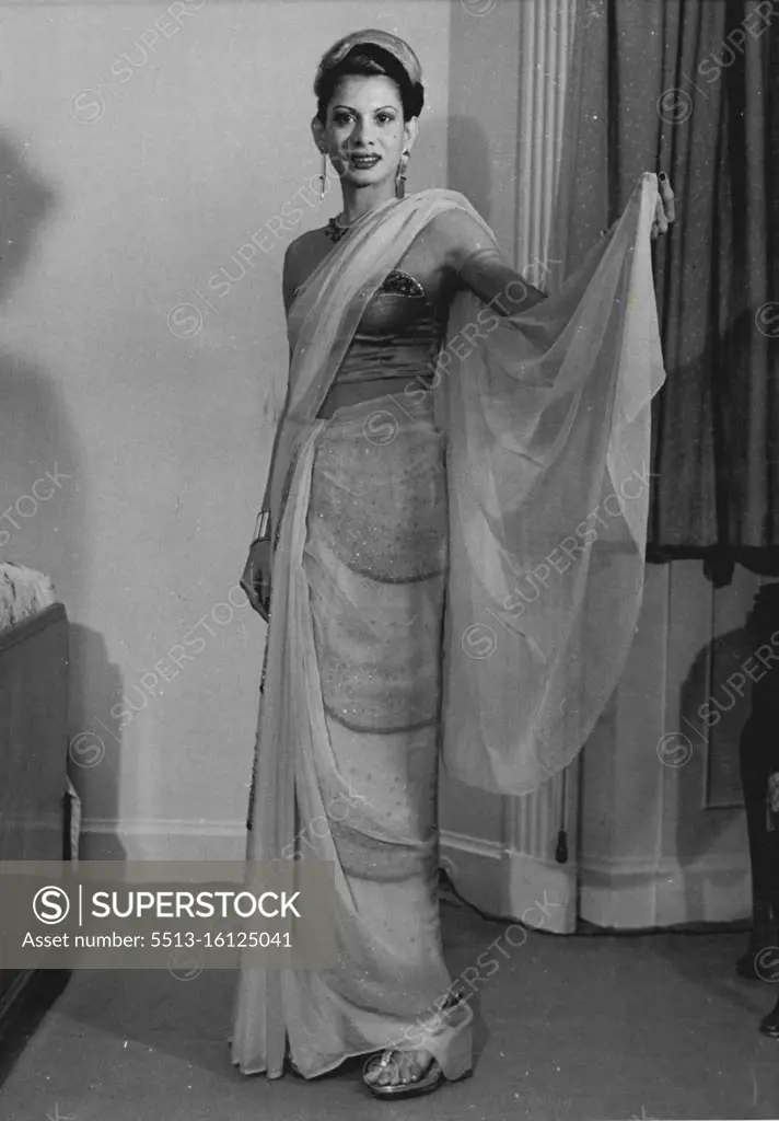 This bare midriff sari, something daringly new in Oriental fashion, is in the wardrobe of Mrs. Onally Gulamhusein, wife of a wealthy Ceylon merchant, who is in London on honeymoon. Onally is only twenty-one-the grey in her hair is artificial. May 22, 1951.