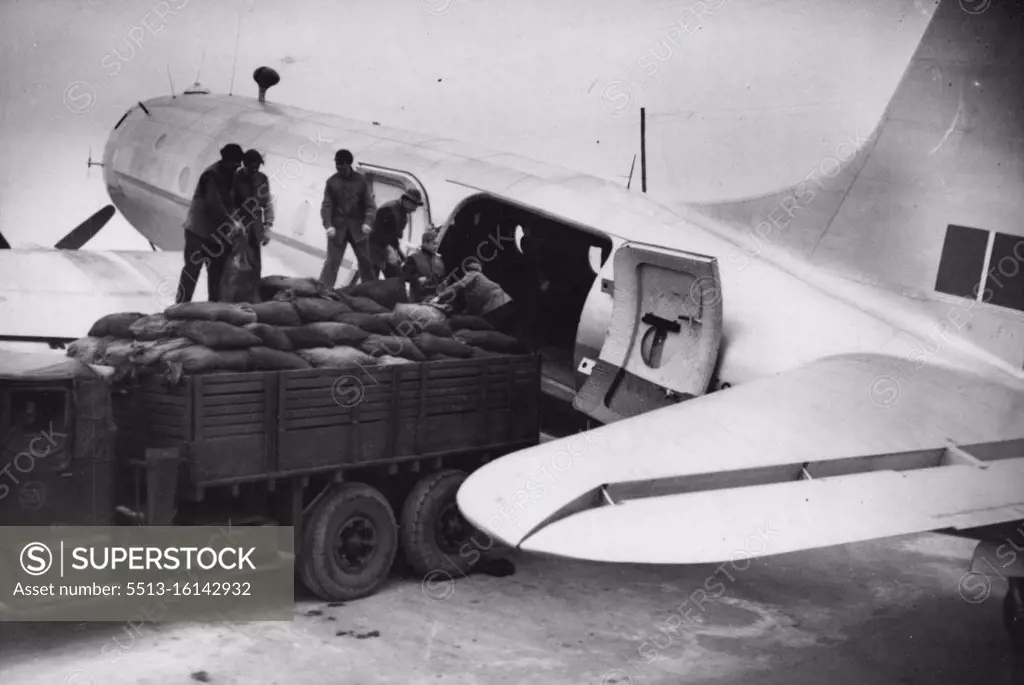 Britain's Latest Planes To Boost Berlin "Air Lift" -- German workmen loading coal into one of the new "Hastings" aircraft at the base near Kiel, in readiness for the flight to Berlin. Eight Handley Page "Hastings" Britain's latest, now being used to increase the R.A.F.'s share in the great Berlin "air lift". Each aircraft is capable of carrying seven and a half tons and will be used mainly for transporting coal. The squadron will work from a specially prepared airfield about 25 miles outside Kiel. November 03, 1948. (Photo by Sport & General Press Agency, Limited).