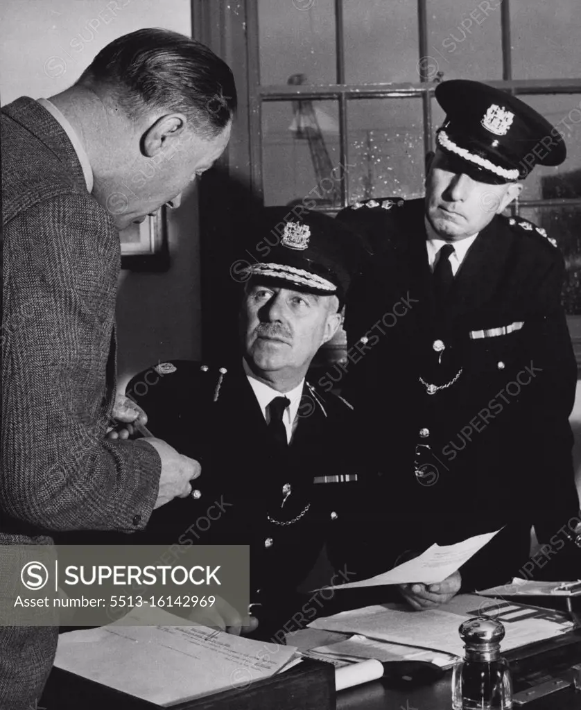 London's Port Police The men at the top -- seated is Mr. W. H. Simmons, Member of the Order of the British Empire and holder of the King's Police Medal. He handed over in the middle of 1950 to Mr. S. F. Cox (right). Both have risen from the ranks of the P.L.A. Police Force. Both Officers regard the maintenance of a perfect standard of routine work as being the basis of all police activity. Left is Inspector March, who heads the Mobile Squad of the C.I.D. July 01, 1950. (Photo by Central Office Of Information Photograph).