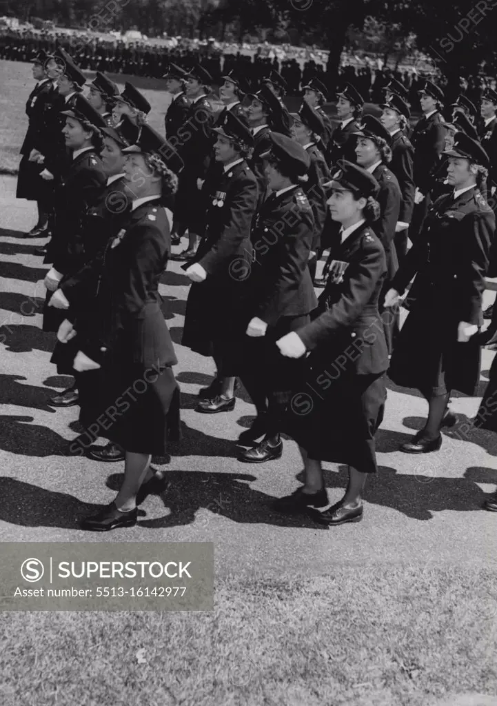 The Queen Reviews the Police. Metropolitan policewomen marching in Hyde Park to-day. Ten thousand policemen and policewomen stood to attention in Hyde Park this afternoon to be reviewed by the Queen. Their dark blue uniforms and glearing buttons, segregated into 37 tightly-packed blocks, brought Londoners their first massed view of Britain's police Force for 19 years. It was in 1935 that Britain's Monarch last reviewed the Force. To-day there were 3,000 London police officers - 60 of them women and representatives from 157 other forces in England, Scotland, Wales and Northern Ireland. July 14, 1954. (Photo by Daily Mail Contract Picture).