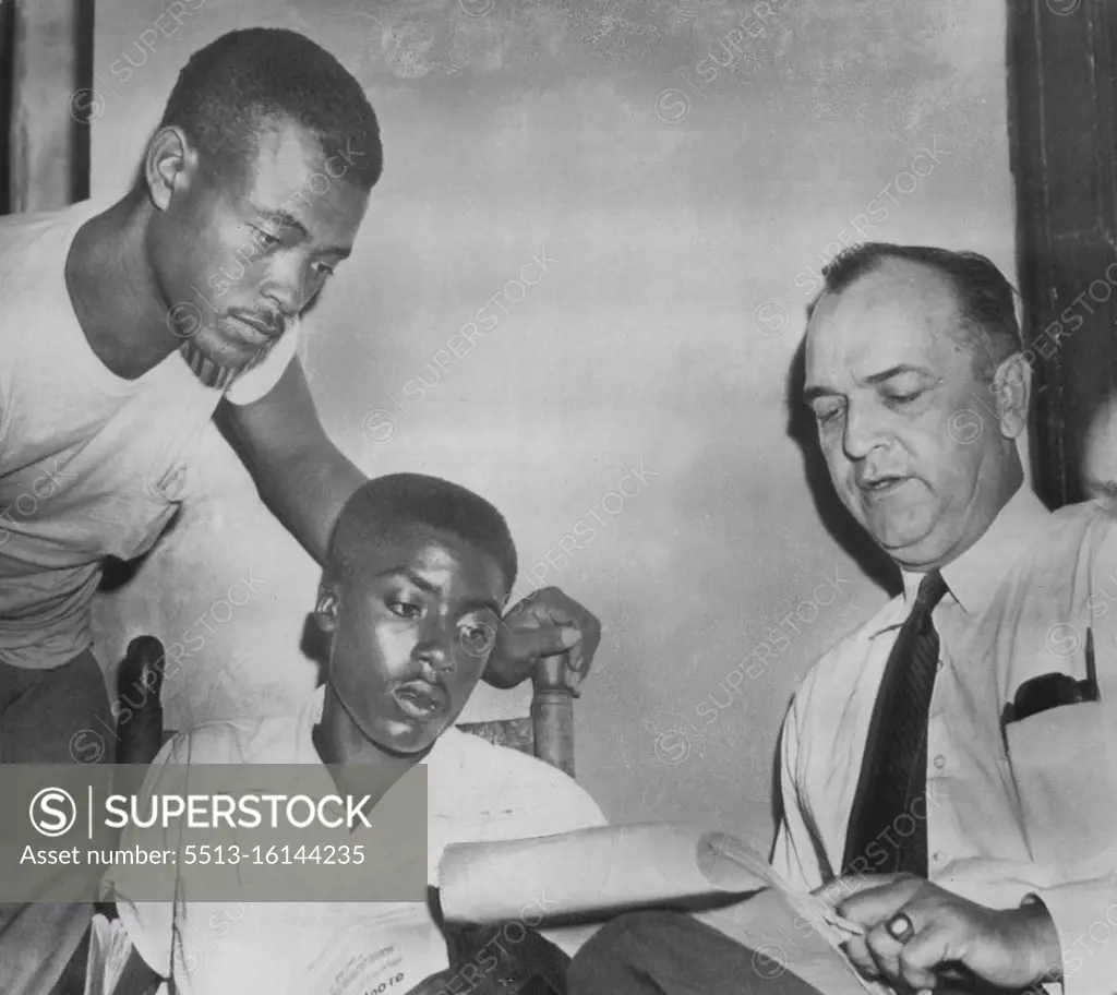 State Witnesses With D.A. -- District Attorney Gerald Chatham (right) talks with state witnesses Walter Billingsley (left) and Willie Reed (center) before court session today in which two men are charged with the murder of Emmett Till. While on the witness stand today Reed told the court he saw J. W. Milam, one of the defendants, at a plantation barn in Sunflower Count on the morning after Till was abducted. September 22, 1955. (Photo by AP Wirephoto).