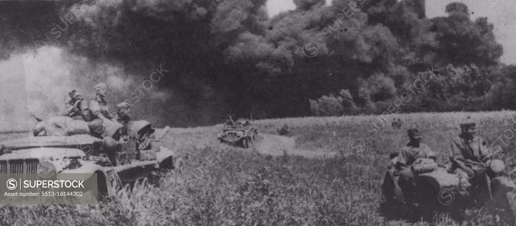 Russians Scorch The Maikop Oilfields -- German motorised units leaving behind burning oil wells of Maikop after failing to subdue the flames. Although the Russians were forced to fall back in the Maikop area, they Caucasus, thus forcing the Germans to give up any attempts to get the fires under control. September 14, 1942. (Photo by Keystone).  