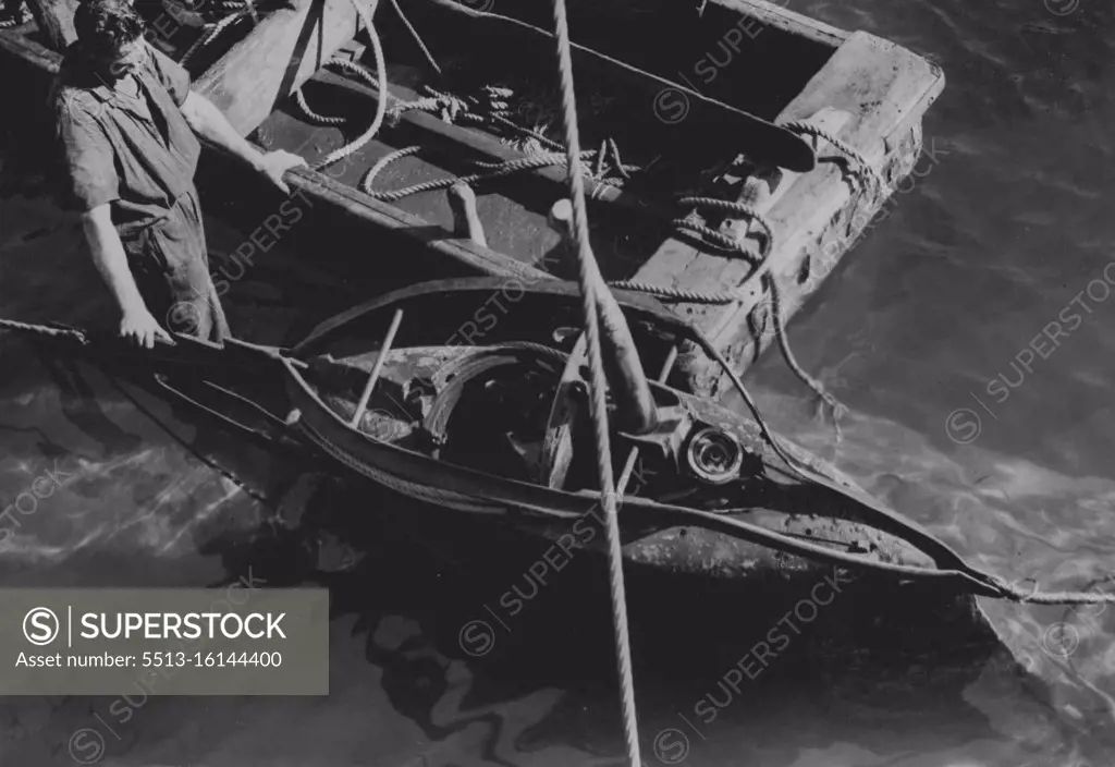 The conning tower is here shown just as the ***** brought to the surface. The hatch was open and the interior flooded. Fifteen feet of the stern of the vessel had been blown away. June 1, 1942. 