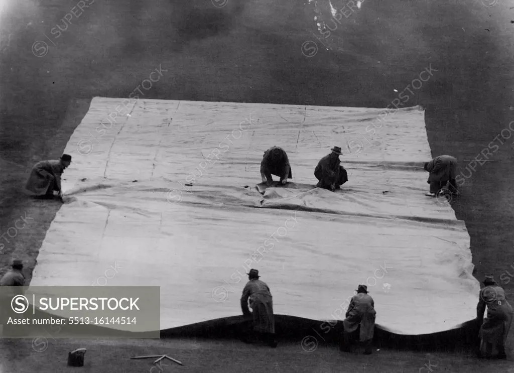 Covering the Wicket at the Melbourne Cricket Ground when ***** stopped play in the shefflied Shield match between Vic & NSW. January 04, 1949.