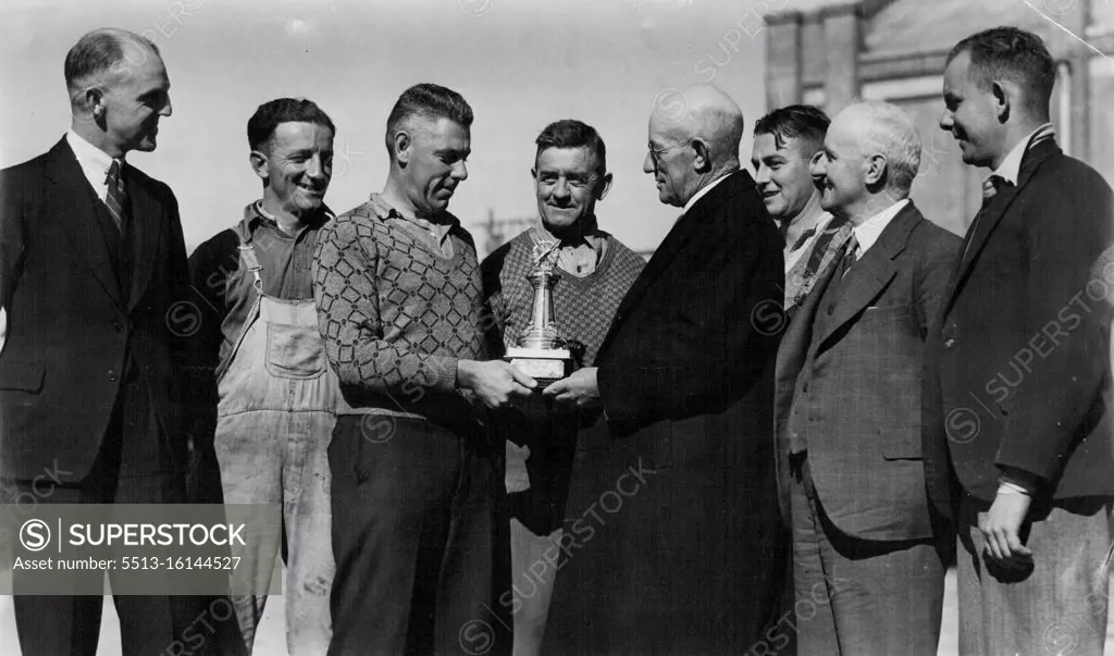 Presentation of "Sun" Challenge Cricket trophy to the Railways Institute Electric car *****, Chullora team, the team has won the trophy for the last 3 seasons, At this season were undefeated. Trophy is presented to premier team in Railway Institute competition. L to R. - W. White, works manager of Patron, ***** (player), W. Williams, (V. Capt) L. Mills, President, Geo Nicholas Director of Institute making presentation, H. Ryon, Sec. J. Russell, Sec of Institute & W. Wand, player. May 29, 1939.